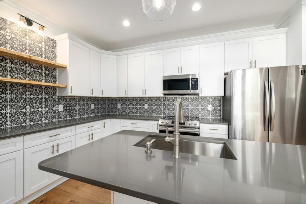 Kitchen with White Cabinets and Tiled Wall