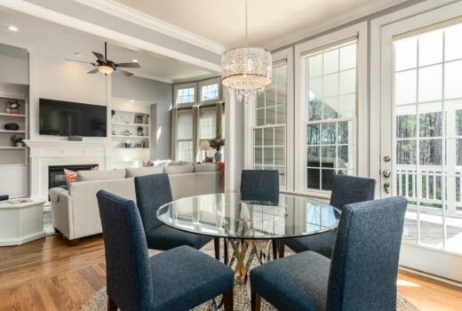 round clear glass-top table and five gray chairs dining se